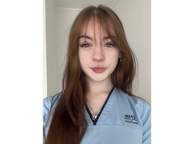 April Watson in an NHS uniform. April is a student who completed the Foundation Apprenticeship in Healthcare. April Watson in an NHS uniform. April is a student who completed the Foundation Apprenticeship in Healthcare.