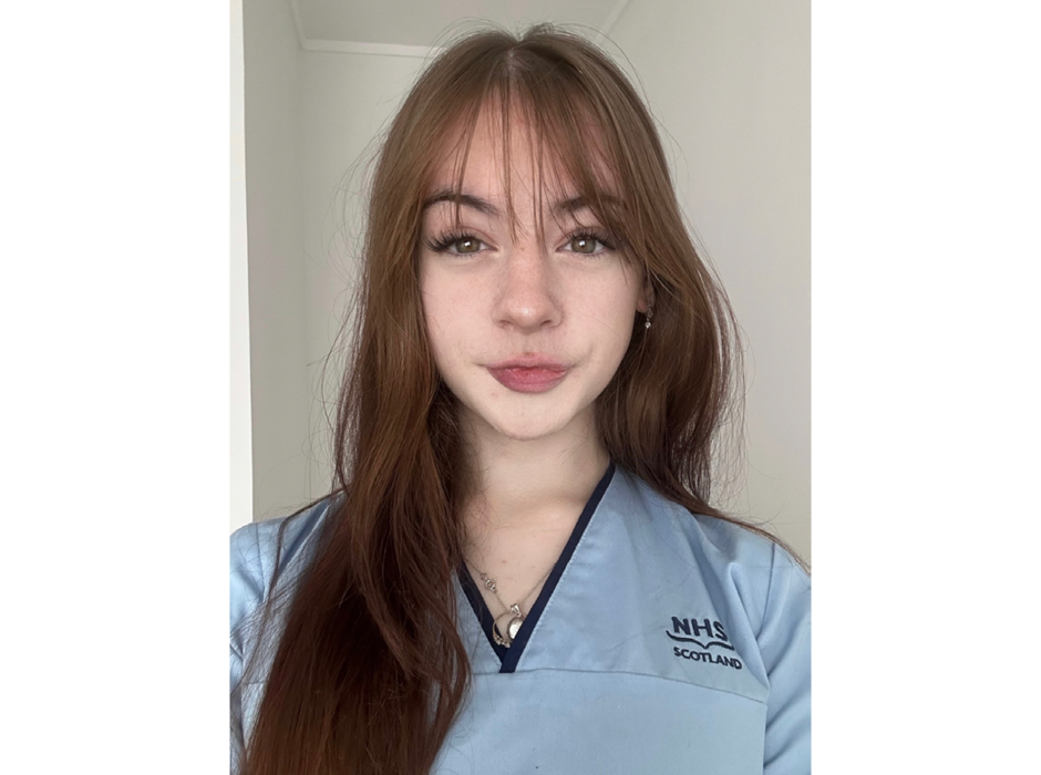April Watson in an NHS uniform. April is a student who completed the Foundation Apprenticeship in Healthcare.