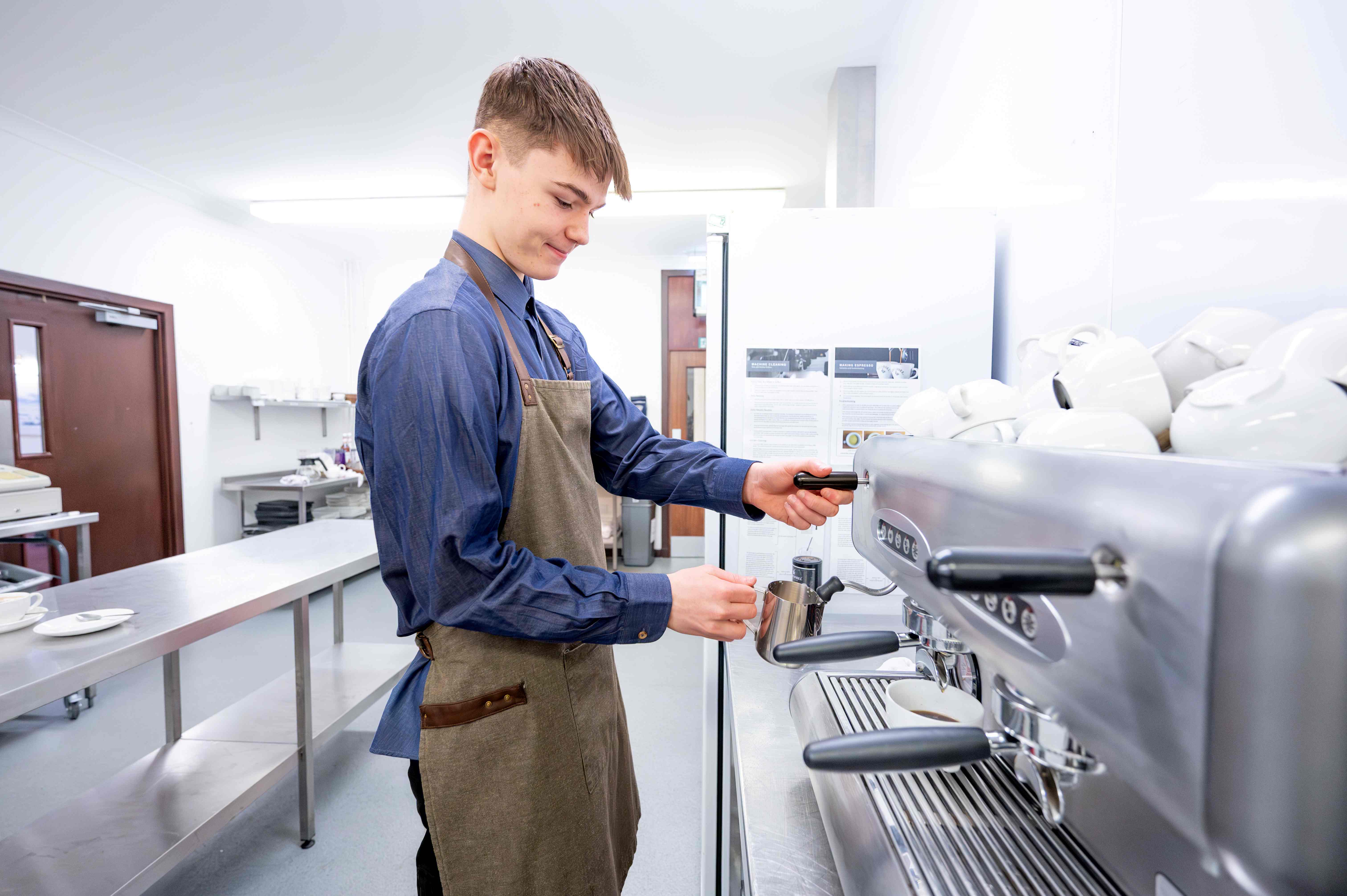 hospitality student using espresso machine in commercial kitchen hospitality student using espresso machine in commercial kitchen
