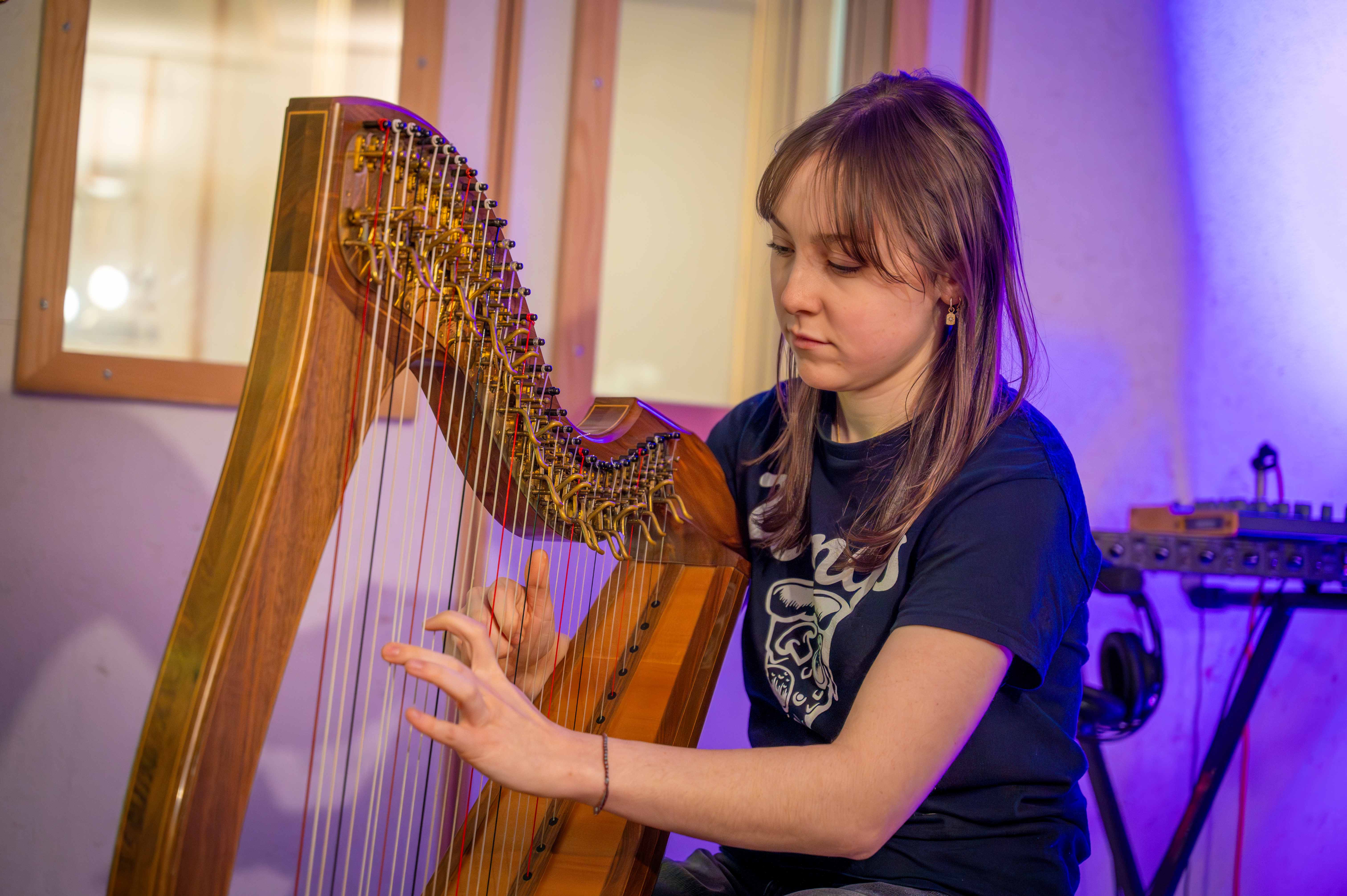 female student playing a clarsach