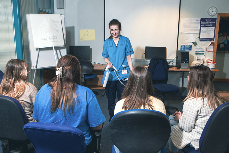 occupational therapist talking to care students