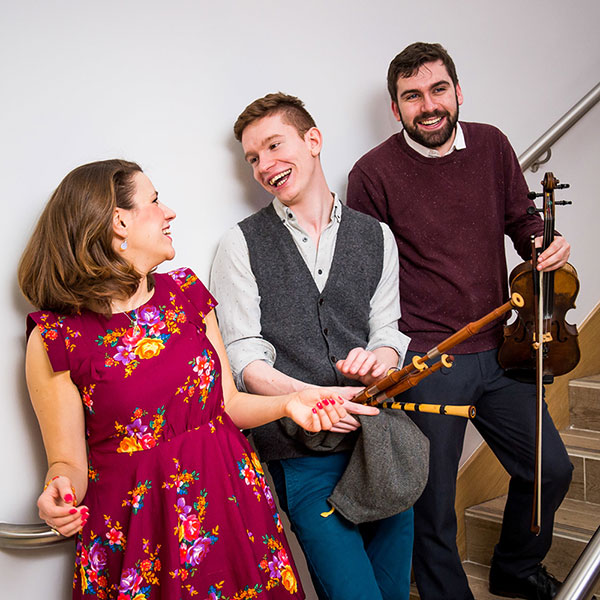 Three musicians standing on some stairs