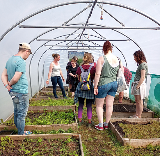 a group of people in a poly tunnel