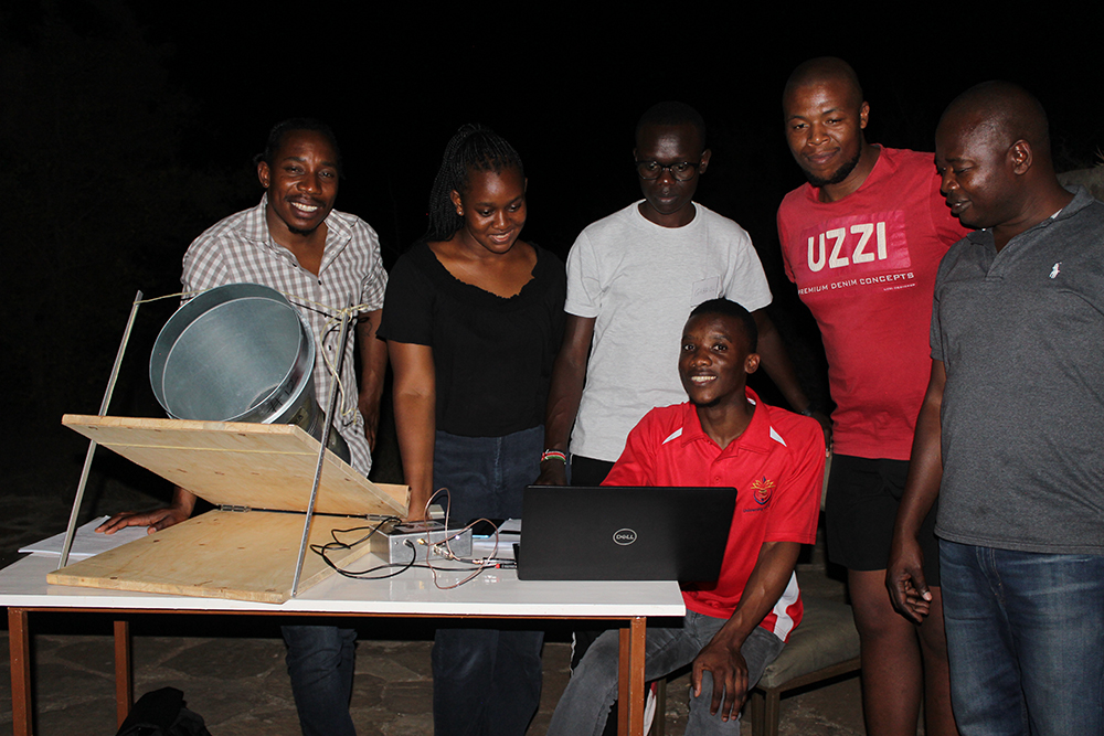 Former Leeds DARA PhD student Dr Willice Obonyo – who is now a lecturer at the Technical University of Kenya - with students using the small radio telescope