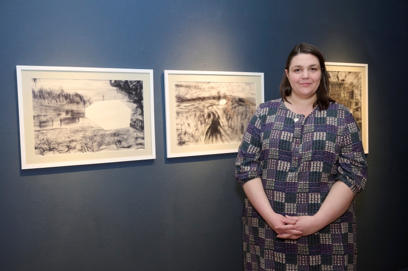 Katy MacLachlan standing in front of artwork